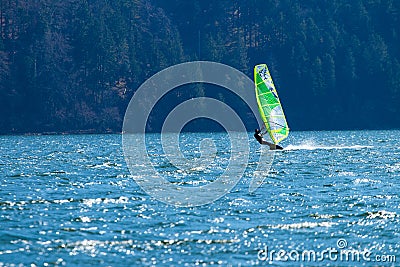Lifestyle windsurfer on lake Alpnach in Switzerland during a windy spring day Editorial Stock Photo