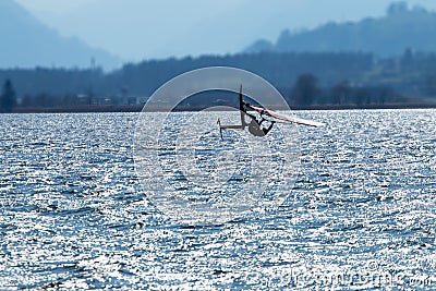 Lifestyle windsurfer on lake Alpnach in Switzerland during a windy day Editorial Stock Photo