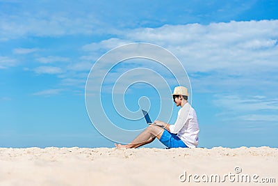 Lifestyle young asian man working on laptop while sitting chill on the beautiful beach, freelance working social on holiday summer Stock Photo