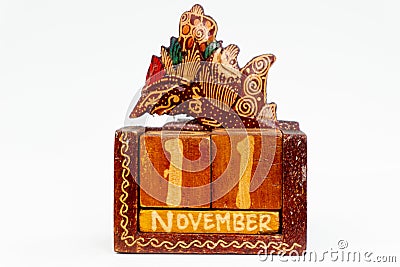 A lifetime calendar in the form of a wayang (javanese puppet) and made of wood Stock Photo