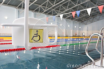 Lift for the descent of people with disabilities into the pool. Stock Photo