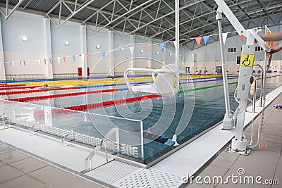 Lift for the descent of people with disabilities into the pool. Stock Photo