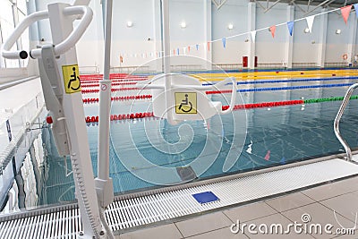 Lift for the descent of people with disabilities into the pool. Stock Photo