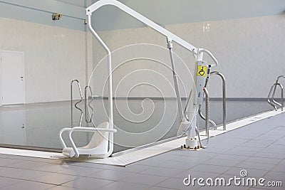 Lift for the descent of people with disabilities into the pool. Stock Photo