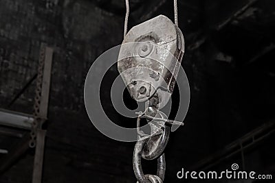 Lifting heavy mechanism equipment industrial crane hook at the factory Stock Photo