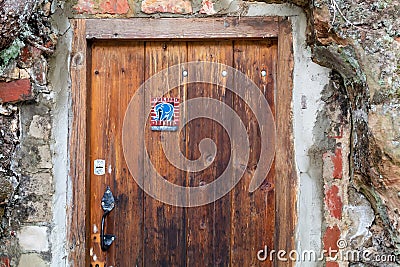 Old weathered wooden door with a funny blue elephant sticker Editorial Stock Photo