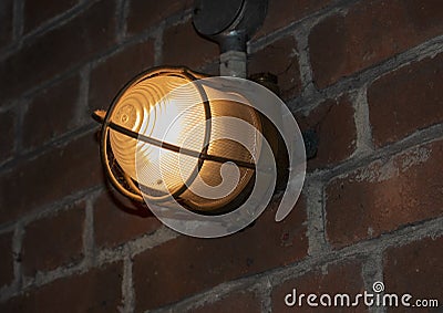 Industrial vintage bunker light on old brick wall Stock Photo