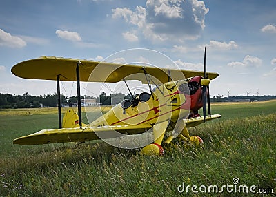 Light aircraft. Light yellow airplane on airport grass. Light general aviation plane on final Stock Photo