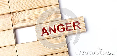 On a light background, wooden blocks with the text ANGER. Close-up top view Stock Photo