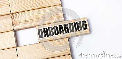 On a light background, wooden blocks with the text ONBOARDING. Close-up top view Stock Photo
