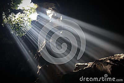 Light Beams in Cave Stock Photo