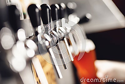 Light beer with large foam in glass against background of hand bartender Stock Photo