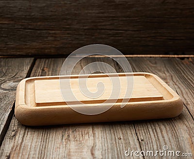 Light beige rectangular empty cutting kitchen board on a wooden background Stock Photo