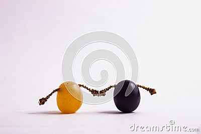Light and black grapes are holding hands Stock Photo