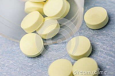 . on a light blue background pills yellow. shallow depth of field Stock Photo