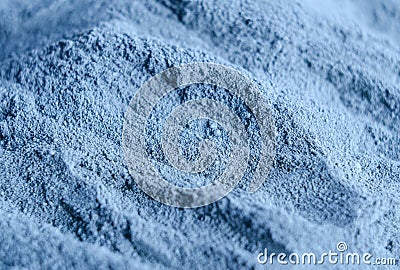 Light blue bentonite facial clay powder alginate mask, body wrap texture close up, selective focus. Abstract background Stock Photo