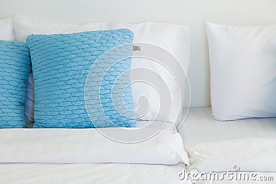 Light blue pillows white bed Stock Photo