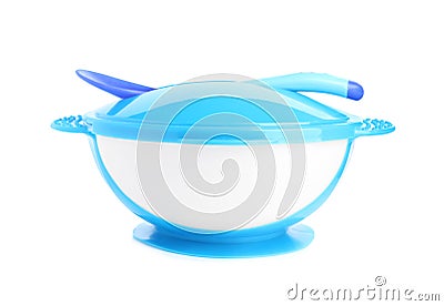 Light blue plastic baby bowl with spoon isolated. First food Stock Photo