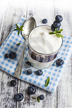 Light breakfast setup with yogurt on white wooden table Stock Photo