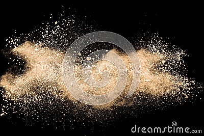 Light brown dust explosion cloud.Brown particles splatter on black background Stock Photo