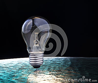 Light bulb on blue and black background Stock Photo