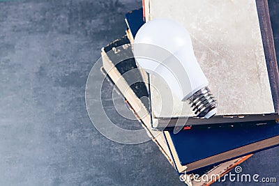 Light bulb on books on table Stock Photo