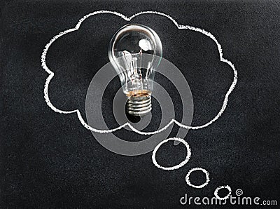 Light bulb on chalkboard. Thinking of new great idea. Brainstorming and creating. Creativity, innovation, inspiration. Stock Photo