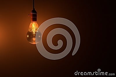 Light bulb glowing in the dark with place for text. 3d rendered Stock Photo