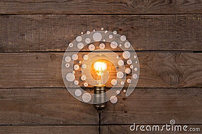 Retro light bulb and group of gears on wooden background - idea, innovation, teamwork and leadership concept. Space for text Stock Photo