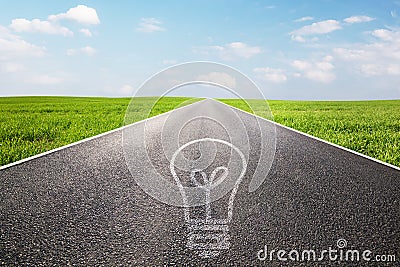 Light bulb symbol on long empty straight road Stock Photo