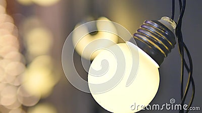 Light bulbs garland close up. Electric bulb shine hanging on wall as decoration for holiday close up Stock Photo