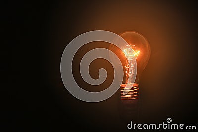 Light bulbs turn on on black background and no wiring with successful concept on thinking concept. Lighting in loft style Stock Photo