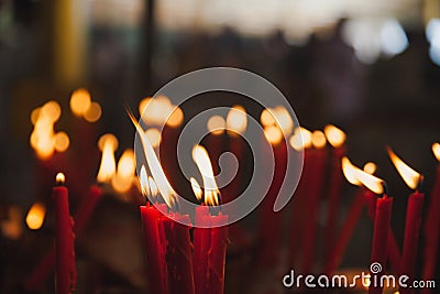 Light candle burning brightly in the black background Stock Photo