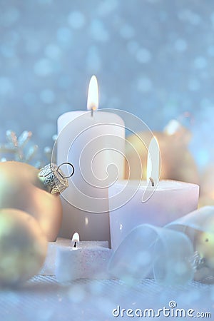 Light Christmas Decorations with Candles, baubles and magic snow Stock Photo