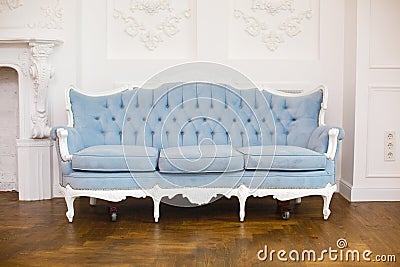 Light classic royal interior with blue soft sofa with fabric upholstery Stock Photo