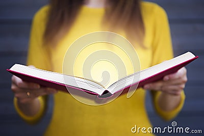 Light coming from book in woman`s hands. Concept of wisdom, reli Stock Photo
