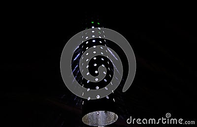 Light coming from the holes of a metallic cylindrical structure. Stock Photo