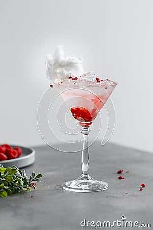 Light composition of an alcoholic cocktail with raspberries and martini. Shot with mint and berries. Stock Photo