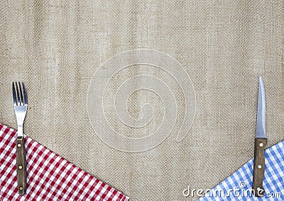 Light fabric along the edges of the table, fork and knife. Background to create a menu of the tavern. Stock Photo