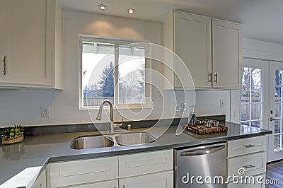 Light filled home interior features small compact kitchen Stock Photo