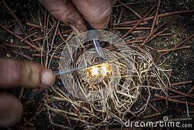 Light fire with tinder with his hands Stock Photo