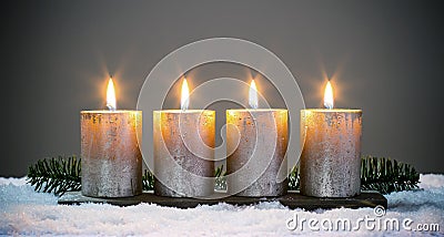 Light four advents candles with matches Stock Photo