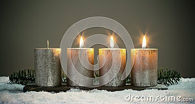 Light four advents candles with matches Stock Photo