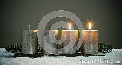 Light four advents candles with matches Stock Photo