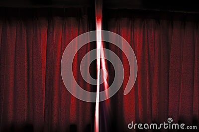 The light go through the about open dark red color curtain of the stage before performing. Stock Photo