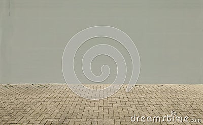 Light gray painted wall with concrete pavement in front. Background for copy space Stock Photo