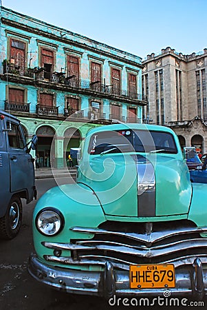 Light green vintage classic yank tank Cuban taxi car of Cuba in front of old building in Havana Editorial Stock Photo