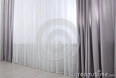 Light grey window curtains and white tulle indoors Stock Photo