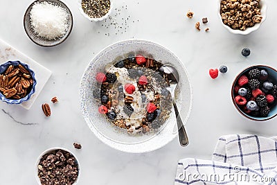 A light and healthy oat yoghurt bowl with all the toppings all around. Stock Photo