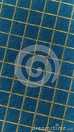 Light lattice or grid on a dark background. Abstract blue and orange vertical backdrop. Inverted squared notebook sheet. Rough Stock Photo